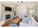 Cozy living room featuring a fireplace, natural light, and comfortable seating at 465 Blue Dragonfly Dr, Charleston, SC 29414
