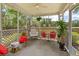 Relaxing screened porch with comfortable seating, a ceiling fan, views of the backyard, and a variety of plants at 465 Blue Dragonfly Dr, Charleston, SC 29414