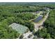 Aerial view of a tennis court area near a neighborhood pond at 465 Blue Dragonfly Dr, Charleston, SC 29414