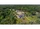An aerial view of the estate with a pool, riding stables, and lush greenery at 4855 Retriever Rd, Wadmalaw Island, SC 29487