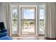 Inviting balcony with water views and seating, accessible through French doors, offers a relaxing outdoor space at 4855 Retriever Rd, Wadmalaw Island, SC 29487
