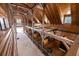 Spacious barn interior featuring wood construction, multiple horse stalls, and ample natural light from large windows at 4855 Retriever Rd, Wadmalaw Island, SC 29487