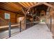 Stunning barn interior with wooden stalls and brick flooring, blending rustic charm with modern functionality at 4855 Retriever Rd, Wadmalaw Island, SC 29487