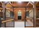 Beautiful view of the barn interior featuring wooden beams and stalls, offering a cozy retreat at 4855 Retriever Rd, Wadmalaw Island, SC 29487
