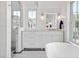 Stylish bathroom featuring a glass-enclosed shower, white vanity, and shiplap walls offers a clean, modern aesthetic at 4855 Retriever Rd, Wadmalaw Island, SC 29487