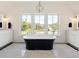 Elegant bathroom with a freestanding tub, large windows, and dual vanities exudes luxury and sophistication at 4855 Retriever Rd, Wadmalaw Island, SC 29487