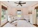 A charming Bedroom is painted in light pink, with a white crib, rocking chair and sheep ottoman at 4855 Retriever Rd, Wadmalaw Island, SC 29487