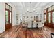 Charming dining room featuring hardwood floors, built-in cabinets, with table set for eight and bright natural lighting at 4855 Retriever Rd, Wadmalaw Island, SC 29487