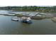 A dock with a boat lift and covered platform for enjoying scenic waterfront views at 4855 Retriever Rd, Wadmalaw Island, SC 29487