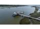 A private boat lift offers easy access to waterfront adventures from the home's dock at 4855 Retriever Rd, Wadmalaw Island, SC 29487