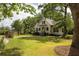 Beautiful home with manicured lawn and mature trees, showcasing the well-kept landscaping at 4855 Retriever Rd, Wadmalaw Island, SC 29487