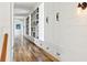 Hallway with built-in bookshelves and cabinets showcases ample storage and charming hardwood floors at 4855 Retriever Rd, Wadmalaw Island, SC 29487