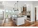 Bright modern kitchen with white cabinets, brick backsplash, stainless steel appliances, and a large center island at 4855 Retriever Rd, Wadmalaw Island, SC 29487