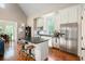 This kitchen features an island with bar seating, stainless appliances, and hardwood floors at 4855 Retriever Rd, Wadmalaw Island, SC 29487