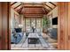 Relaxing sitting room boasting a wood ceiling, comfortable seating, a TV, and scenic views from the large windows at 4855 Retriever Rd, Wadmalaw Island, SC 29487