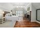 Airy main bedroom with cathedral ceiling, fireplace, French doors, and hardwood floors at 4855 Retriever Rd, Wadmalaw Island, SC 29487