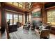 Cozy wood paneled office with a fireplace, desk, comfortable chairs, and scenic views for a productive workspace at 4855 Retriever Rd, Wadmalaw Island, SC 29487
