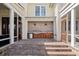 Outdoor kitchen with brick flooring, a built-in grill, and wooden cabinetry is perfect for entertaining guests at 4855 Retriever Rd, Wadmalaw Island, SC 29487
