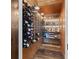 Charming wine cellar with wooden walls, bottle racks, and an illuminated display of liquors and barware at 4855 Retriever Rd, Wadmalaw Island, SC 29487