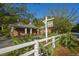 Inviting amenity center with a white picket fence and lush landscaping adds charm and curb appeal at 493 Nelliefield Trl, Wando, SC 29492