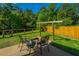Landscaped backyard with a rustic firepit and sitting area for outdoor entertainment at 493 Nelliefield Trl, Wando, SC 29492