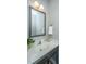 Bathroom with a white countertop sink, decorative mirror, and neutral wall color at 493 Nelliefield Trl, Wando, SC 29492