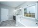 Bathroom featuring a soaking tub and a vanity with a large mirror at 493 Nelliefield Trl, Wando, SC 29492