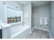 Bathroom showcasing a soaking tub and separate shower with glass door at 493 Nelliefield Trl, Wando, SC 29492