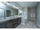 Bathroom showcasing dual vanities, dark cabinets, and a separate soaking tub at 493 Nelliefield Trl, Wando, SC 29492