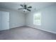 Spacious bedroom with neutral carpet, ceiling fan, and large window at 493 Nelliefield Trl, Wando, SC 29492