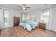 Bedroom featuring hardwood floors, two windows, ceiling fan and en-suite bath at 493 Nelliefield Trl, Wando, SC 29492