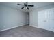 Spacious bedroom with neutral carpeting, ceiling fan, and double closet at 493 Nelliefield Trl, Wando, SC 29492