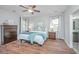 Bedroom featuring hardwood floors, two windows, ceiling fan and en-suite bath at 493 Nelliefield Trl, Wando, SC 29492