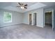 Expansive bedroom with neutral carpet, trey ceiling, and a large window at 493 Nelliefield Trl, Wando, SC 29492