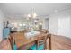 Bright dining room featuring a wooden table, blue upholstered chairs and natural light at 493 Nelliefield Trl, Wando, SC 29492