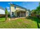 Exterior of home featuring a screened porch, firepit, and spacious, grassy backyard at 493 Nelliefield Trl, Wando, SC 29492