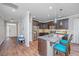 Modern kitchen with stainless steel appliances, granite countertops, and stylish blue pendant lighting at 493 Nelliefield Trl, Wando, SC 29492