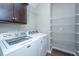 Bright laundry room with white washer and dryer and wooden floor at 493 Nelliefield Trl, Wando, SC 29492