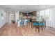 Cozy living space featuring hardwood floors, a kitchen island, and ample natural light at 493 Nelliefield Trl, Wando, SC 29492