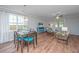 Open-concept living room with a dining area, comfortable seating, and a view of the backyard at 493 Nelliefield Trl, Wando, SC 29492