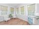 Charming sunroom with lots of natural light and a comfortable seating area at 493 Nelliefield Trl, Wando, SC 29492