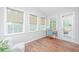 Inviting sunroom featuring natural light and hardwood floors, ideal for a home office at 493 Nelliefield Trl, Wando, SC 29492
