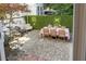 Outdoor dining area set on brick patio, surrounded by lush landscaping and a privacy hedge at 5 Smith St, Charleston, SC 29401