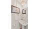 Powder room with pedestal sink, golf decor, decorative lighting and designer touches at 5 Smith St, Charleston, SC 29401