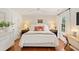 Charming bedroom with hardwood floors, a ceiling fan, and a large bed with bright pillows at 5 Smith St, Charleston, SC 29401