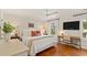 Bright bedroom with hardwood floors, a large bed, a ceiling fan, and a desk at 5 Smith St, Charleston, SC 29401