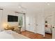 Bedroom featuring hardwood floors, a large bed, closet and view to an office area at 5 Smith St, Charleston, SC 29401