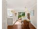 Sunlit dining area with hardwood floors, a charming table setting, and views to an outdoor patio at 5 Smith St, Charleston, SC 29401