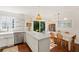 Open kitchen and dining area features wood floors, white cabinets, marble countertops, and a view to the yard at 5 Smith St, Charleston, SC 29401