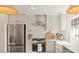 Kitchen with stainless steel appliances, white cabinetry, subway tile backsplash and white marble countertops at 5 Smith St, Charleston, SC 29401